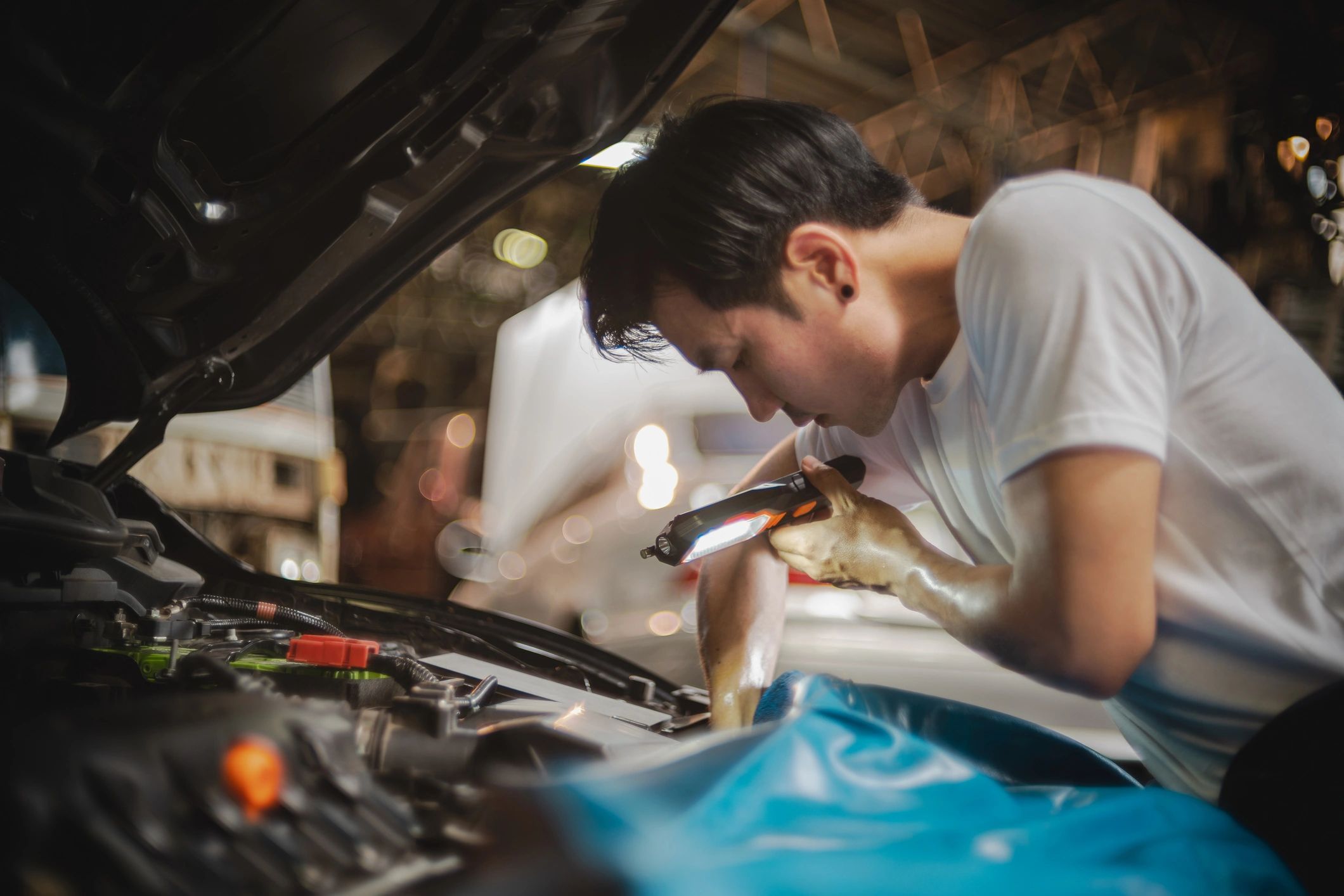 Technician inspecting an engine bay