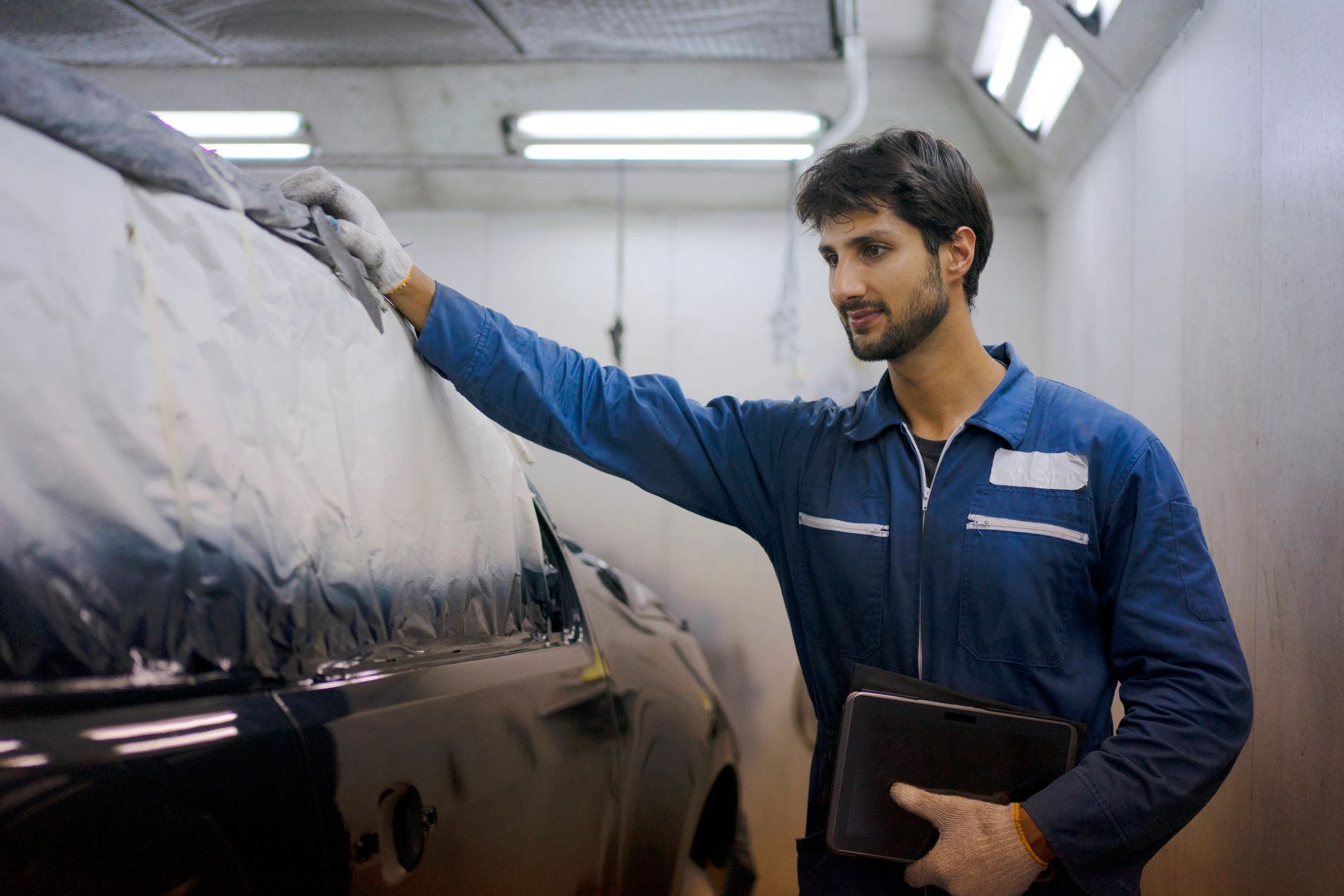 Technician reviewing a service checklist in a garage