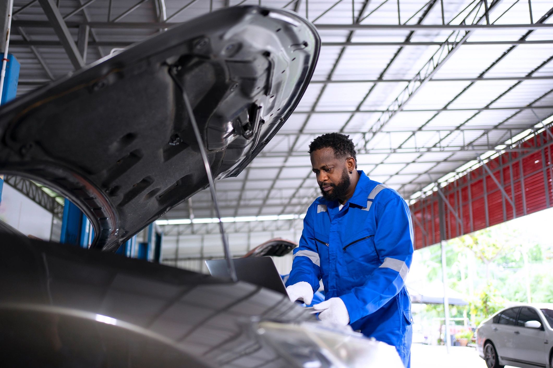 Mechanic inspecting a vehicle in a repair shop