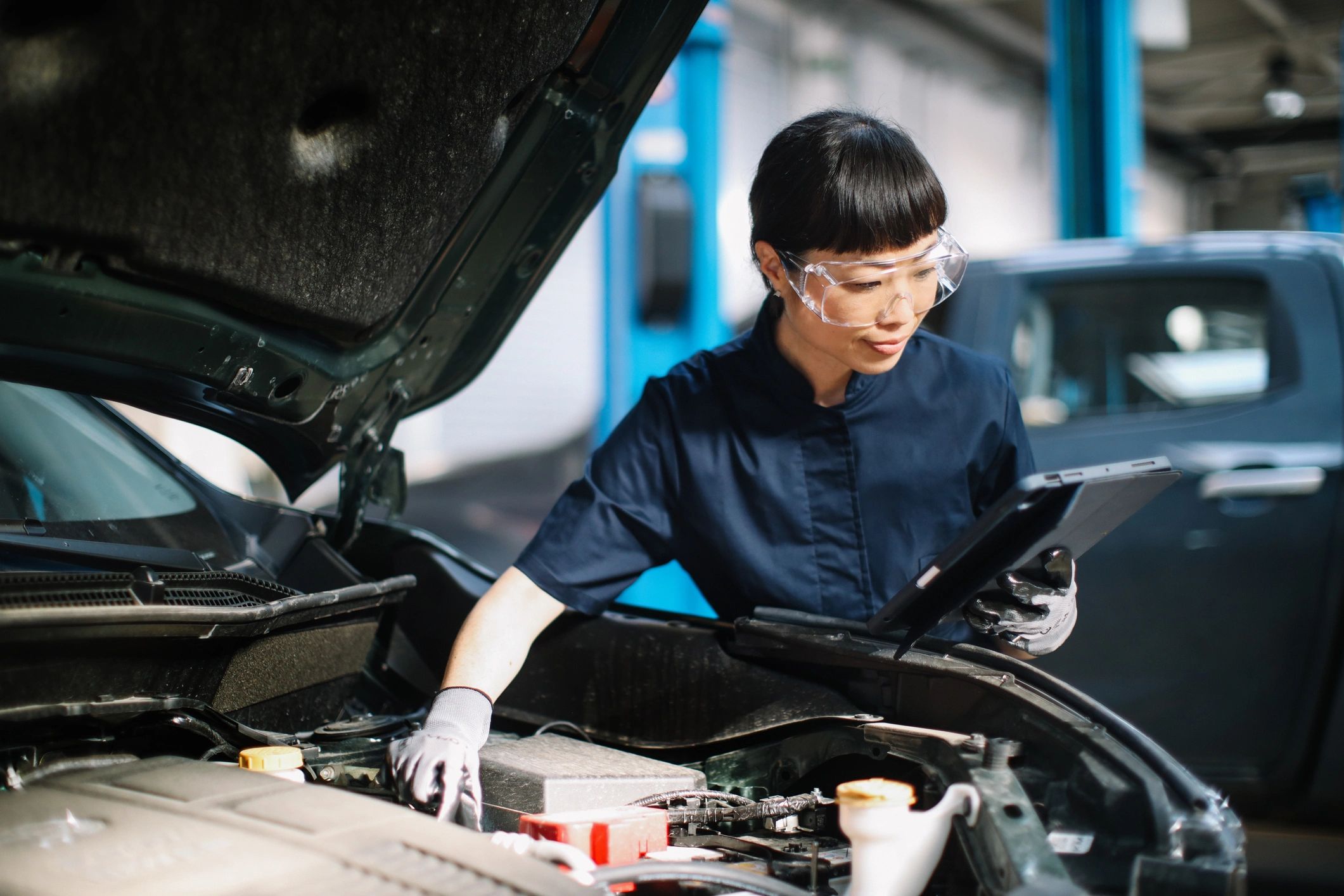 Technician performing a vehicle inspection in a repair shop