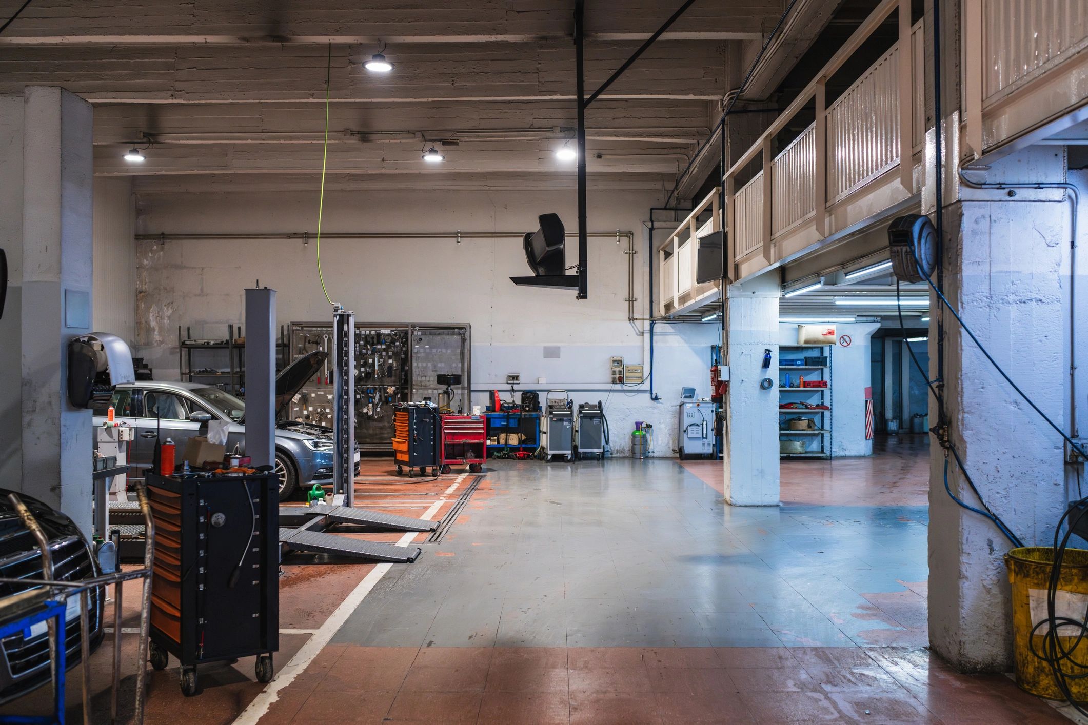 Clean, modern auto repair shop with vehicle lifts and toolboxes