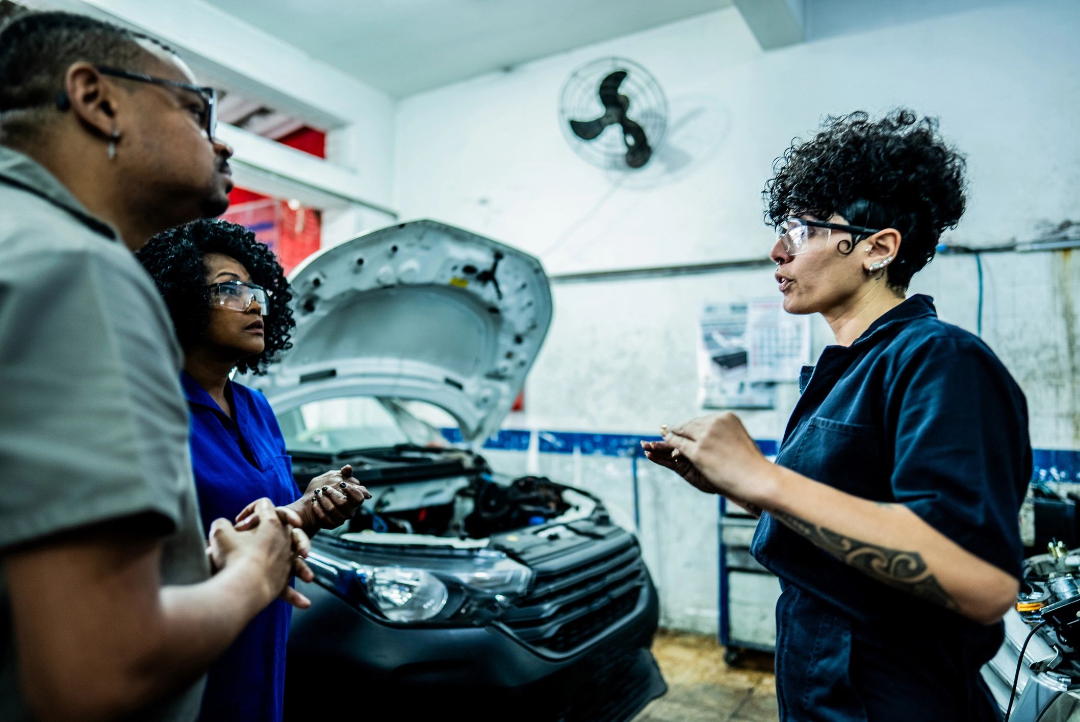 Mechanics collaborating in a repair shop