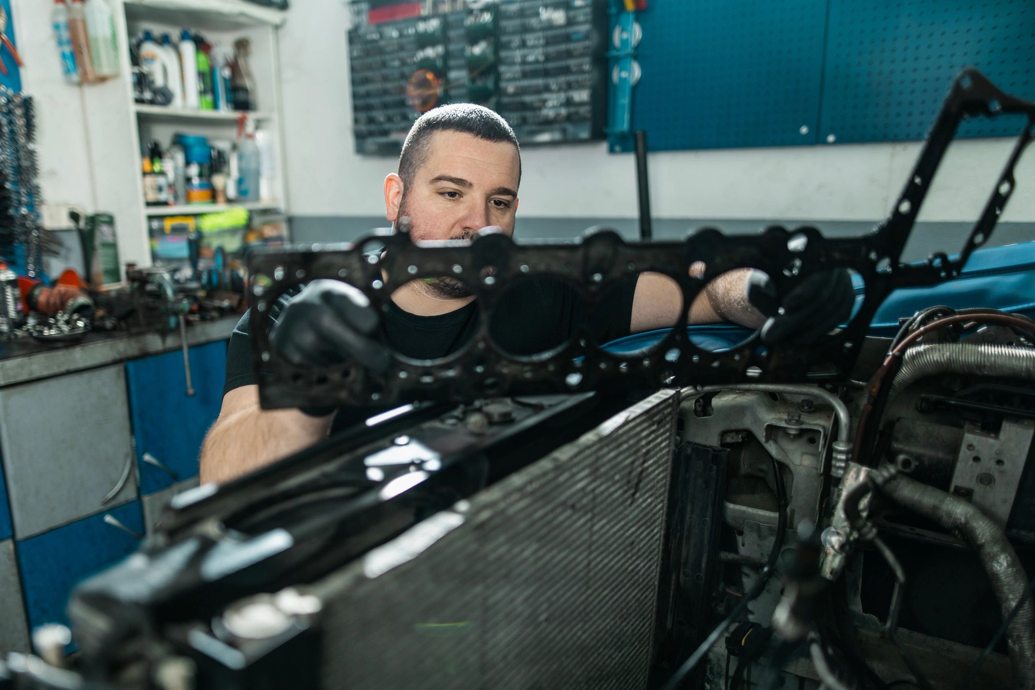 Mechanic holding an engine gasket during repair inspection