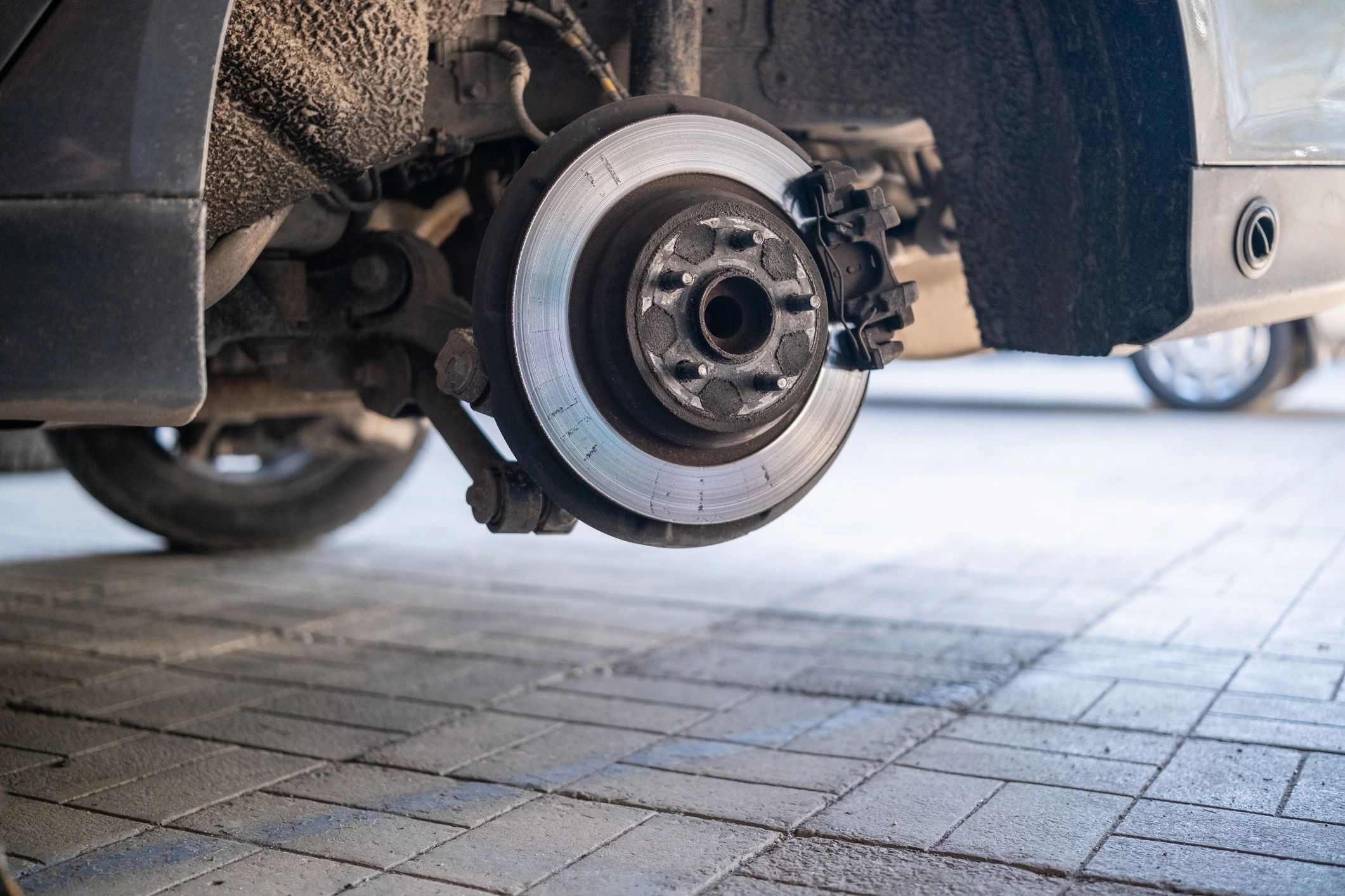 Brake rotor and caliper exposed during service