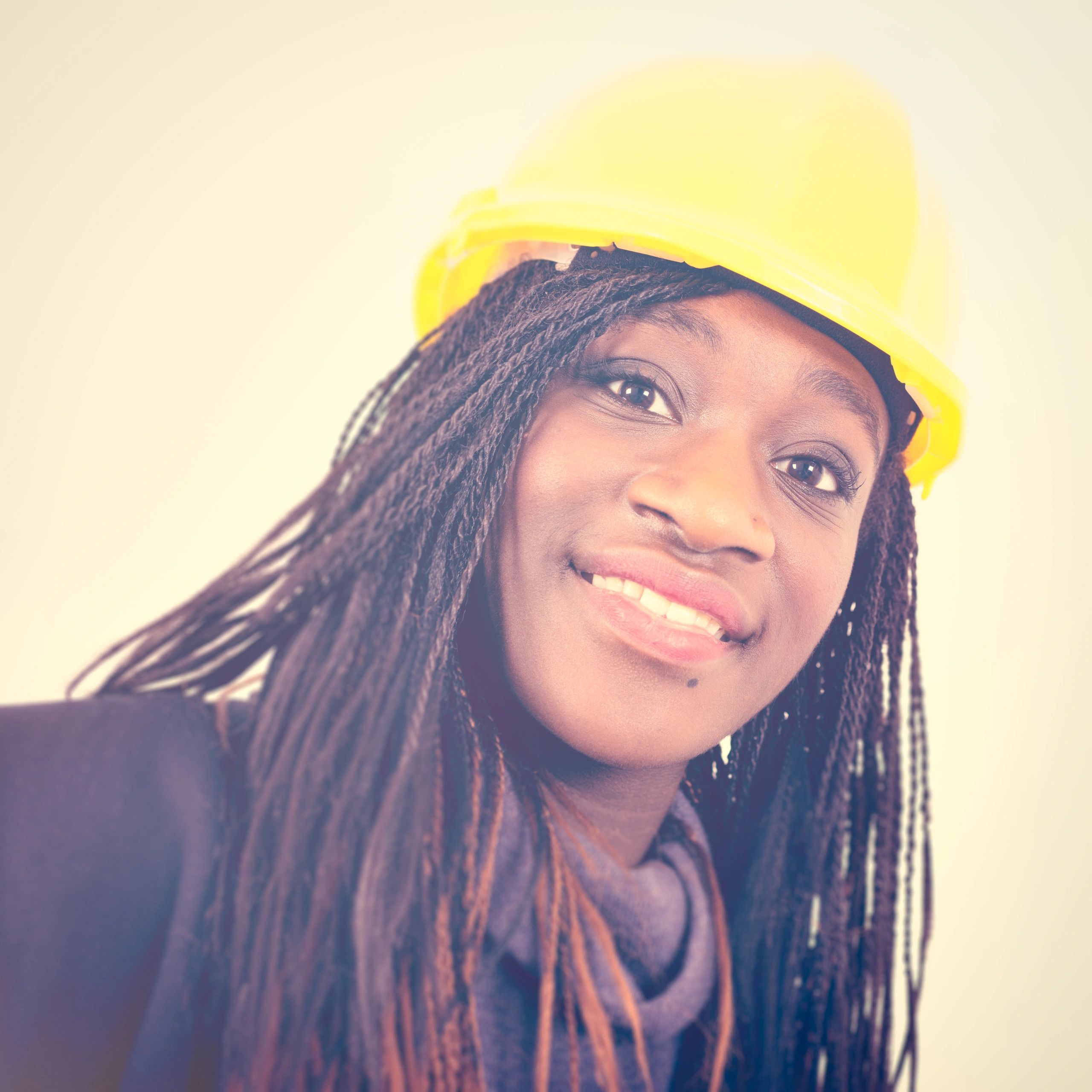 Portrait of a professional woman in a workshop helmet